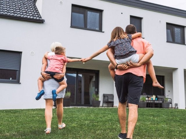 A family walking towards their home